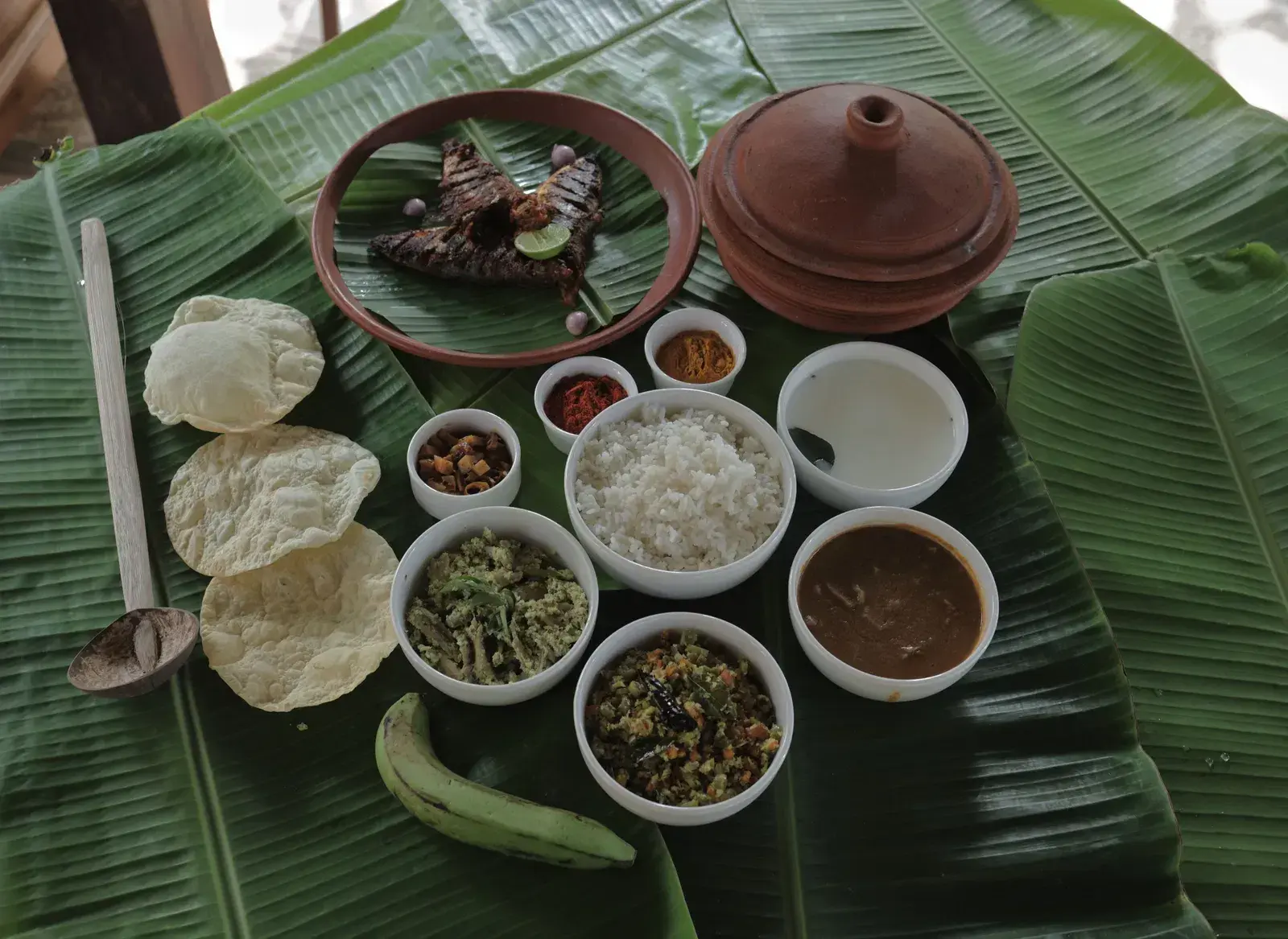 An assortment of various foot items placed on banana leaves at Samiira on Ashtamudi Lake.
