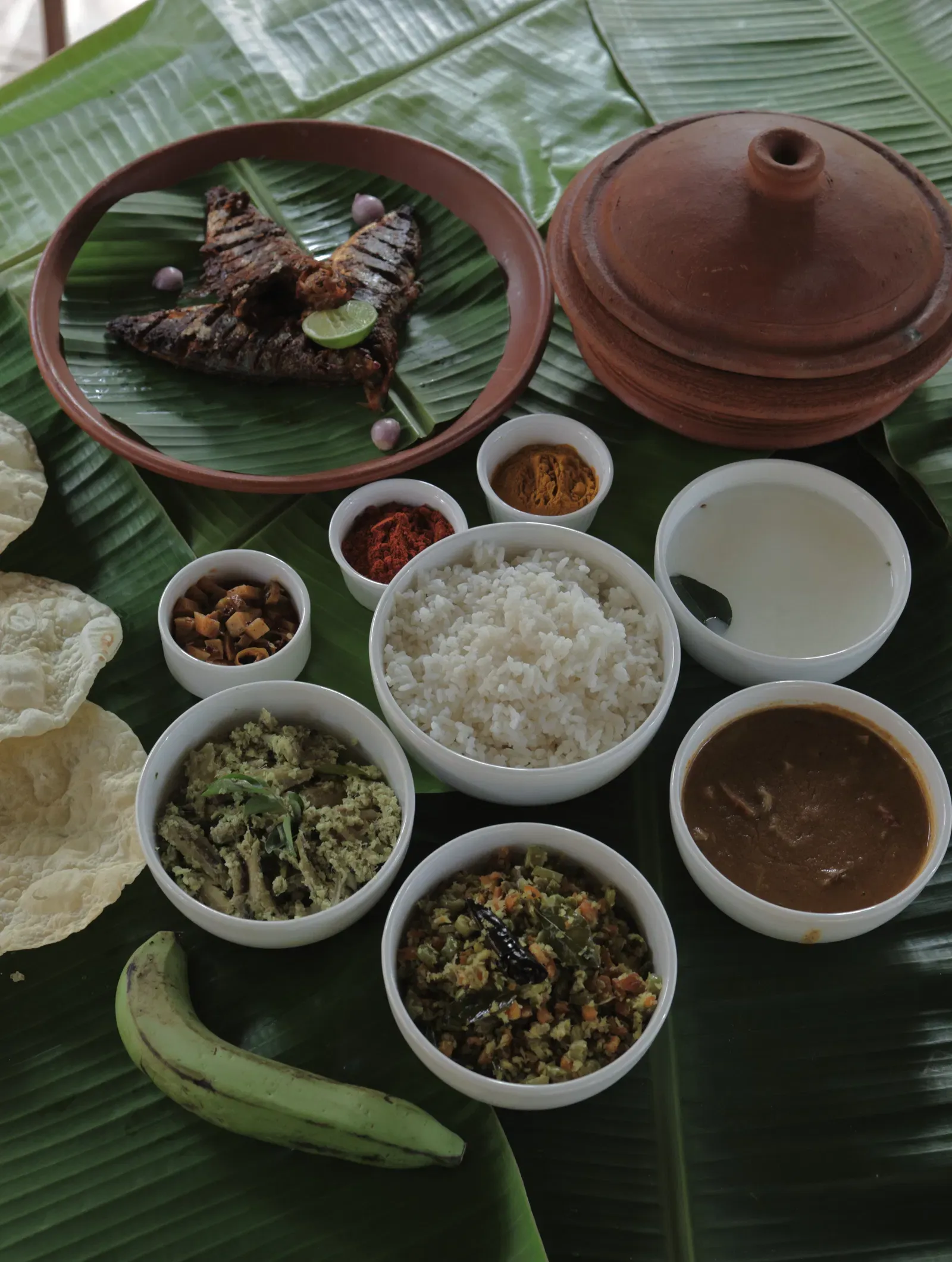 An assortment of various foot items placed on banana leaves at Samiira on Ashtamudi Lake.