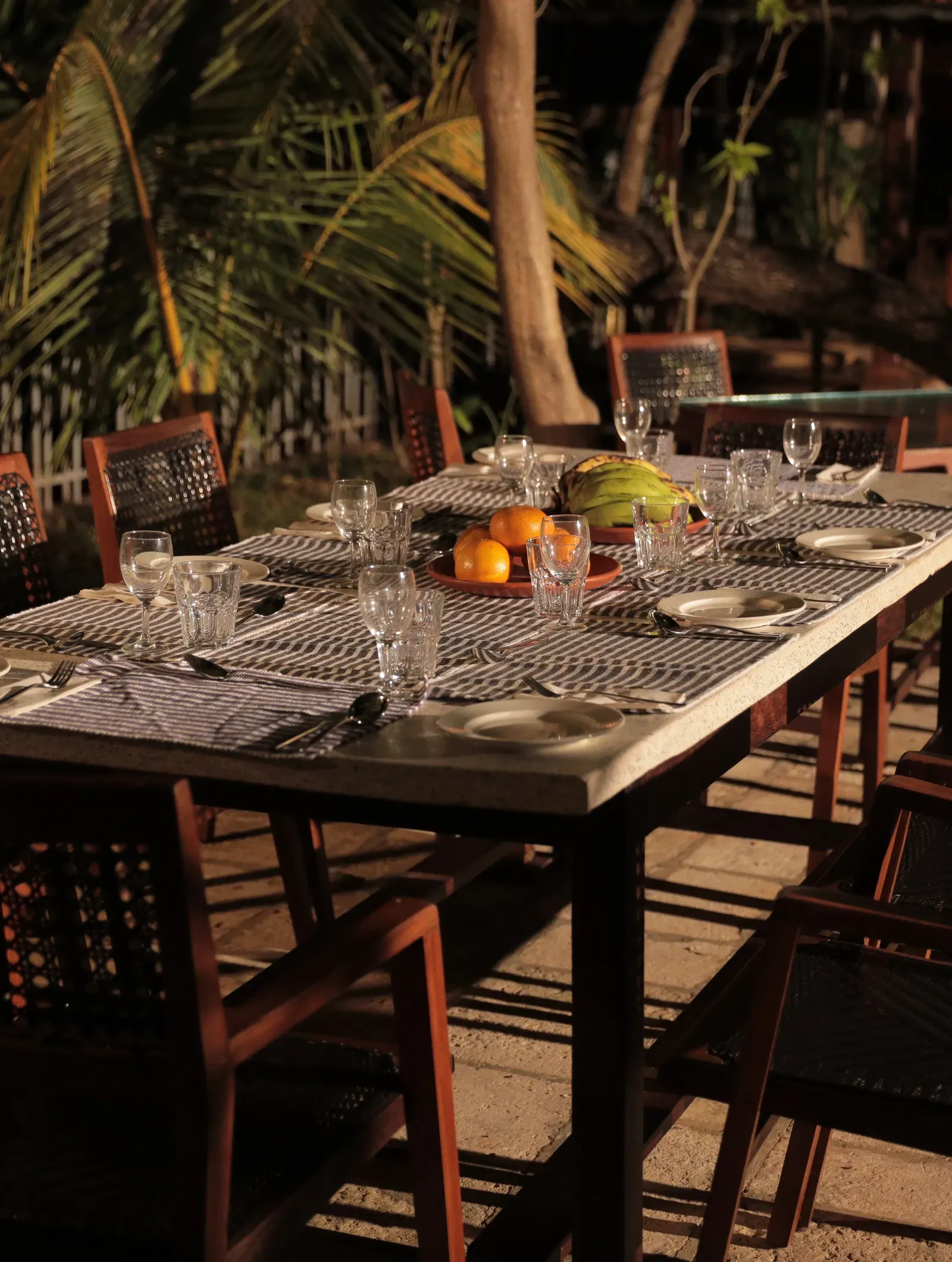 An outdoor seating area at Manger Cafe at Samiira on Ashtamudi Lake.