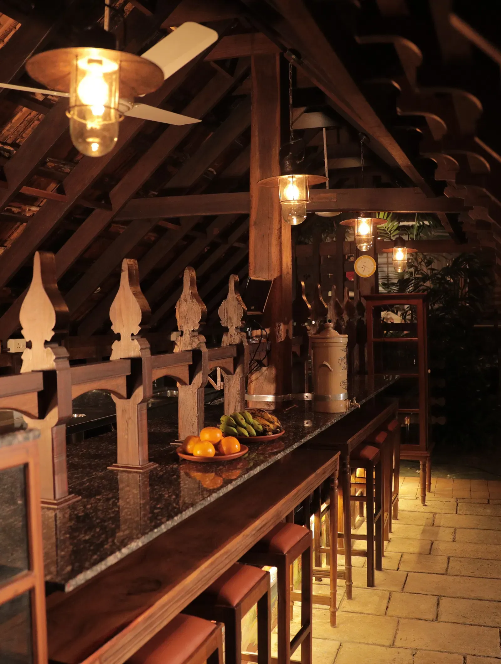 Seating area at the Manger Cafe with a wooden theme at Samiira on Ashtamudi Lake