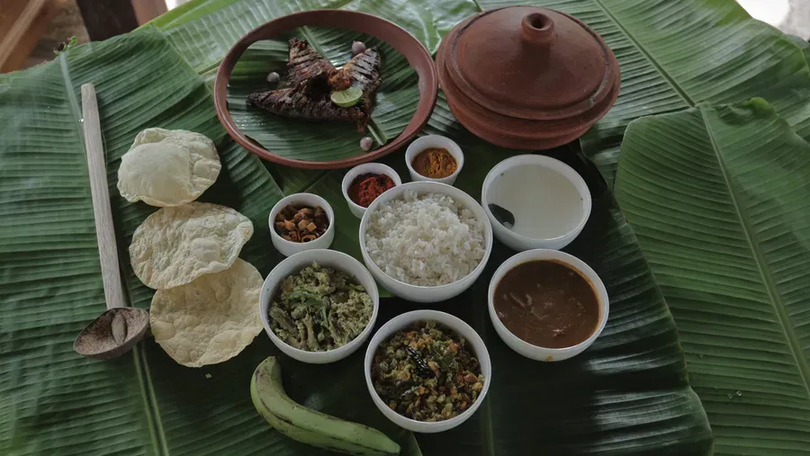 An assortment of various foot items placed on banana leaves at Samiira on Ashtamudi Lake.