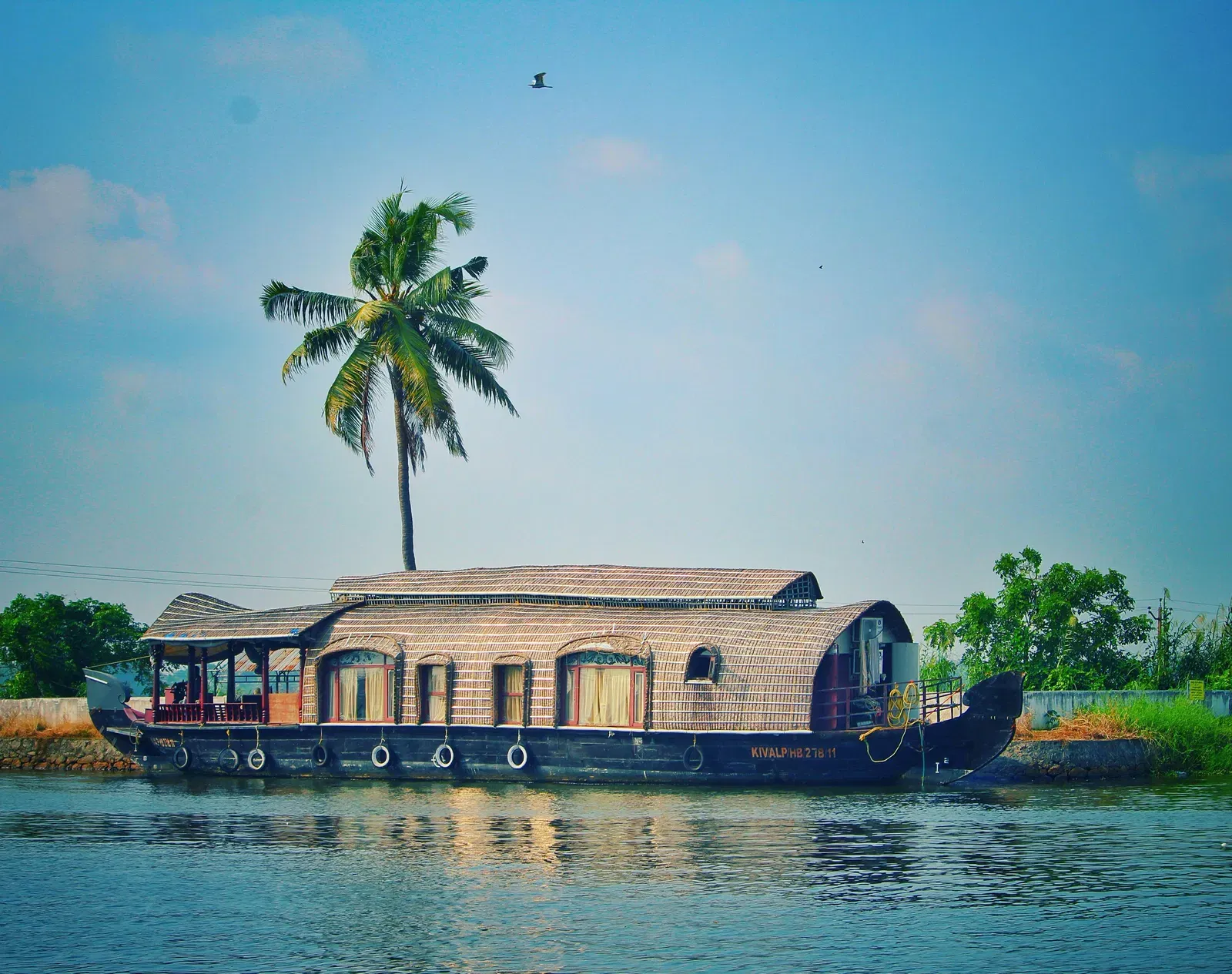 A houseboat passing by in a lake.
